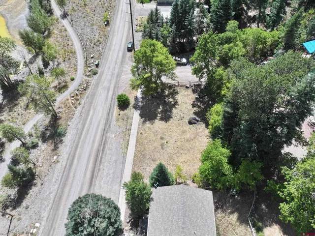 an aerial view of a house with garden space and street view