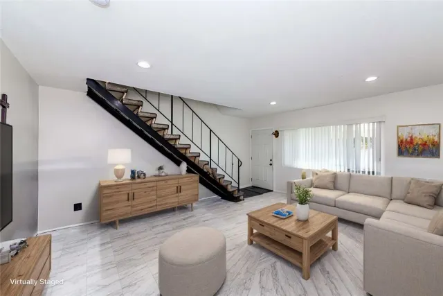 a living room with furniture and a stairs