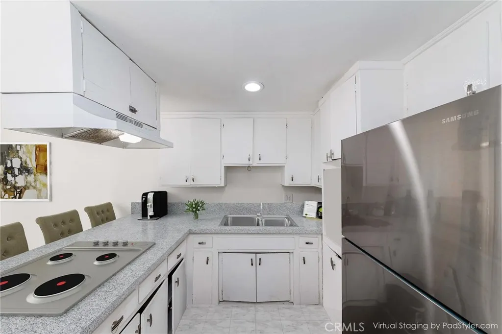 12292 Ranchero Avenue Garden Grove, CA 92843 - Photo 18 of 28 a kitchen with stainless steel appliances granite countertop a washer and dryer