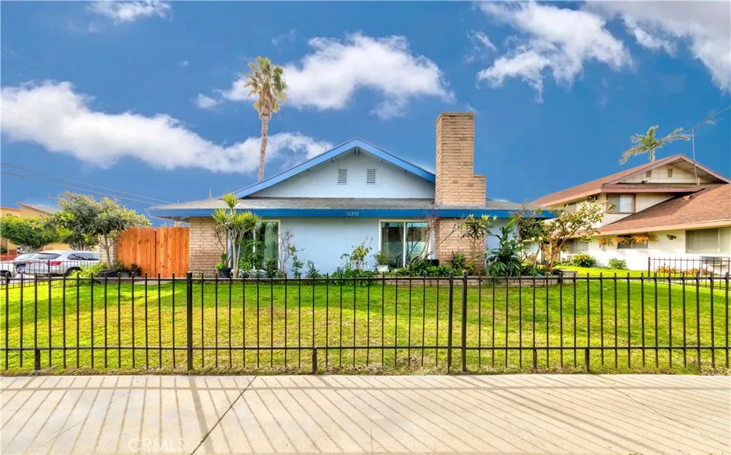 12292 Ranchero Avenue Garden Grove, CA 92843 - Photo 26 of 28 a view of a house with a big yard and potted plants