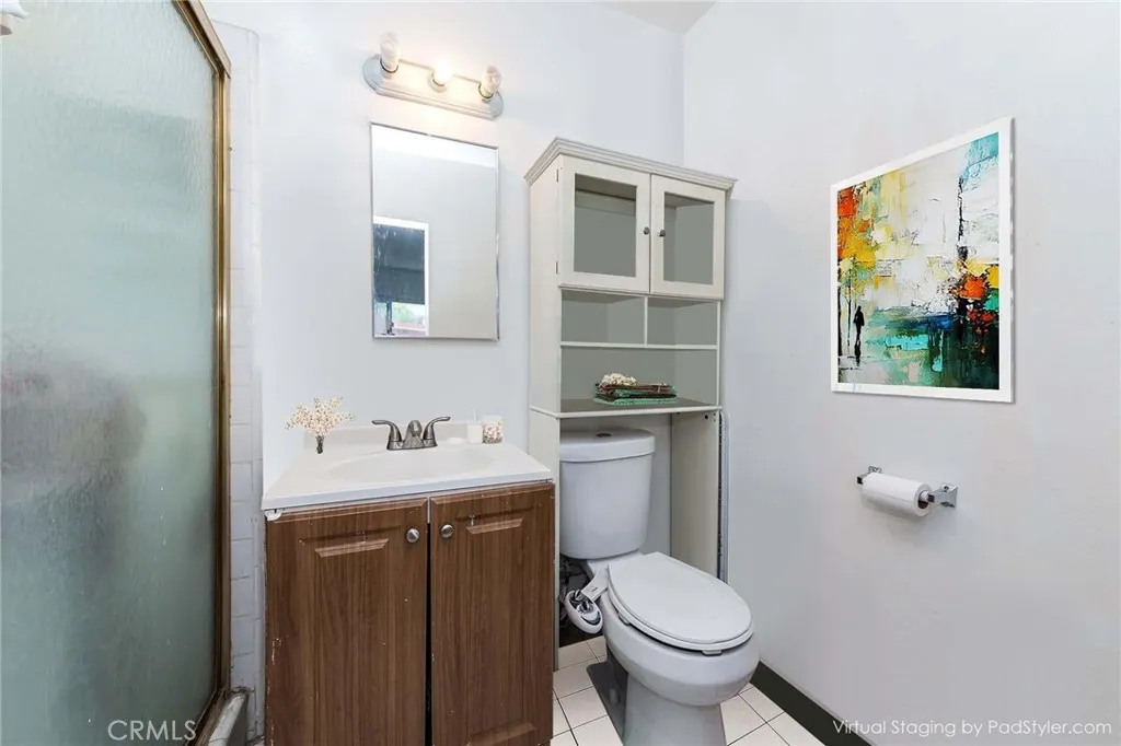 12292 Ranchero Avenue Garden Grove, CA 92843 - Photo 9 of 28 a bathroom with a toilet sink and mirror