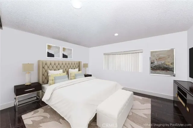 a bedroom with a bed and a night stand