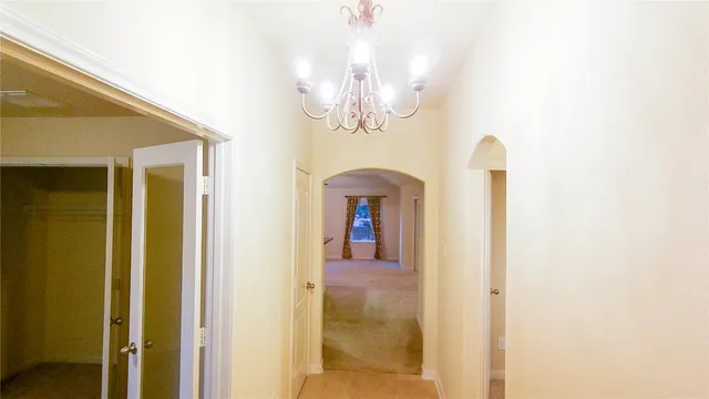 a view of a hallway with a chandelier