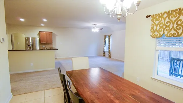a view of a kitchen with furniture and wooden floor