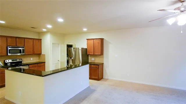 a kitchen with stainless steel appliances a refrigerator and a stove