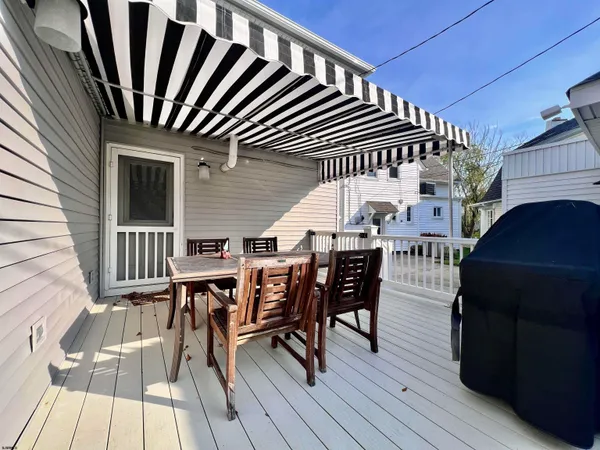 a dinning table and chairs in patio of the house