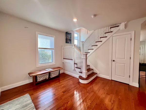 a view of a room with wooden floor and stairs
