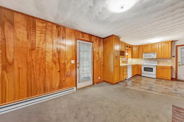 a view of an empty room with a kitchen