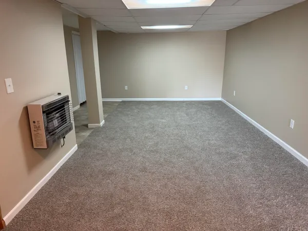 an empty room with closet and mirrors