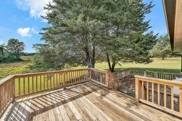 a view of balcony with wooden floor and fence