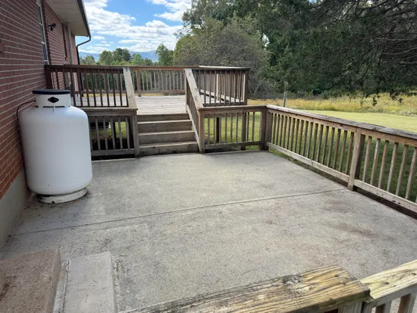 a view of balcony with wooden floor and fence