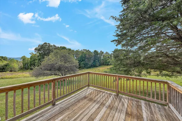 a view of a house with porch and wooden fence