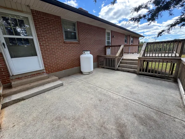 a view of a field of grass and trees