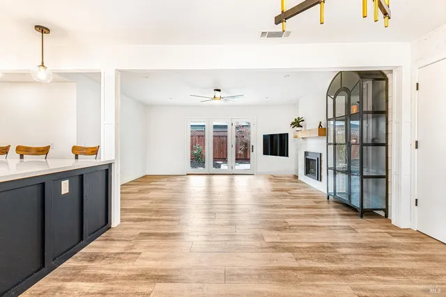 a view of a living room and kitchen with furniture wooden floor and window