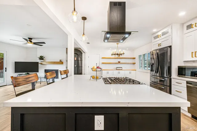 a kitchen with kitchen island a sink appliances and cabinets