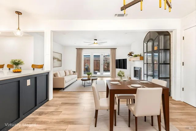 a living room with furniture a rug and white walls