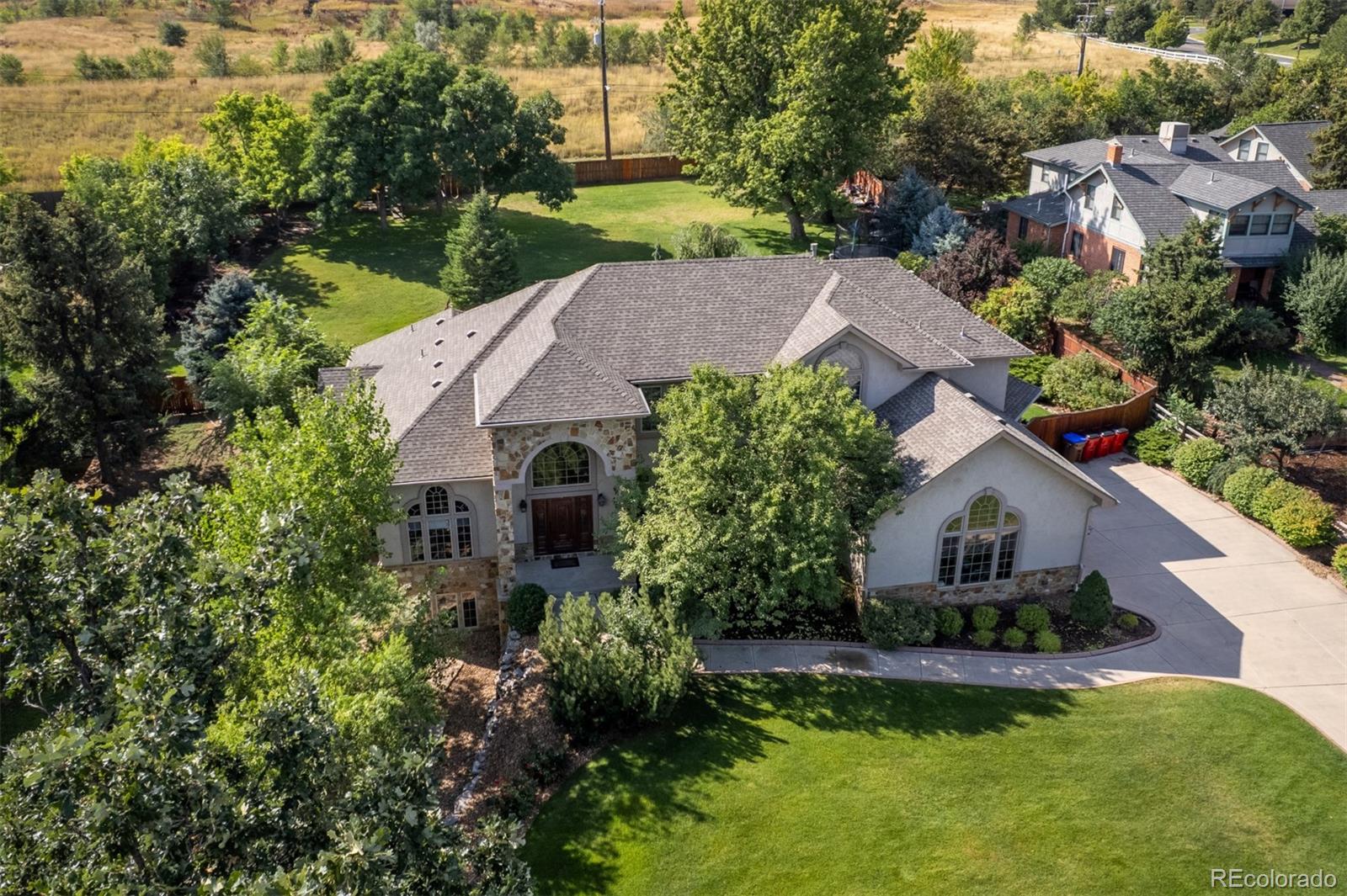 an aerial view of house with yard and swimming pool