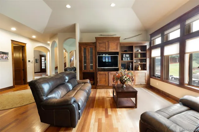 a living room with furniture fireplace and flat screen tv