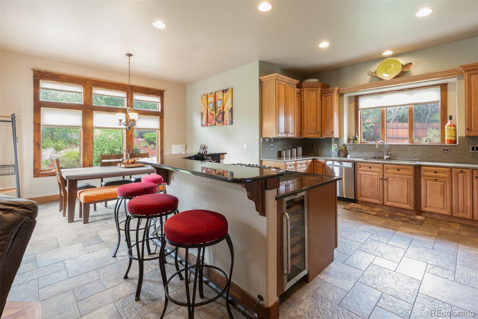 13680 Wide Acres Road Golden, CO 80401 - Photo 15 of 26 a kitchen with stainless steel appliances granite countertop a stove sink and cabinets