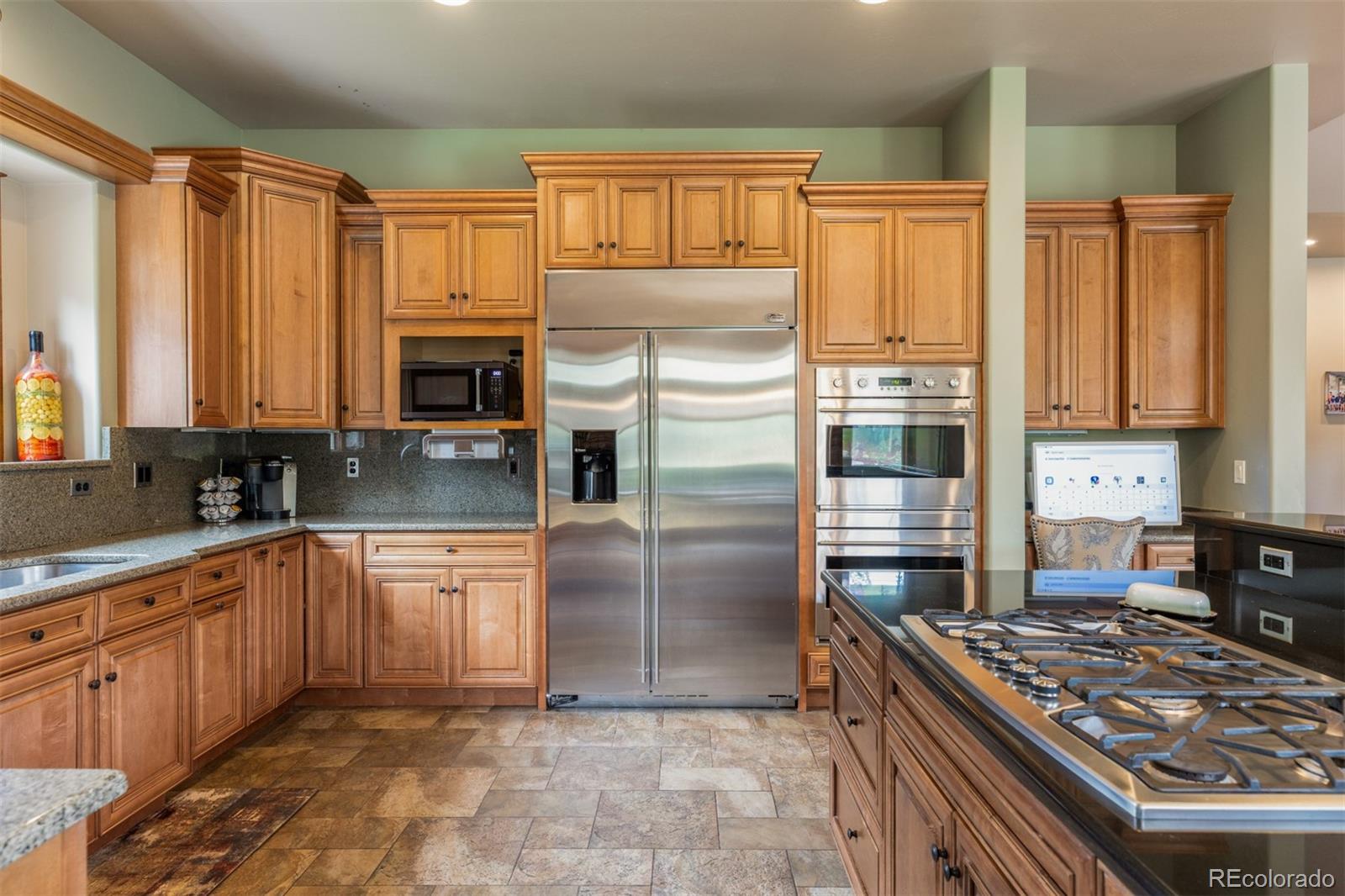 13680 Wide Acres Road Golden, CO 80401 - Photo 16 of 26 a kitchen with stainless steel appliances granite countertop a stove top oven a sink and dishwasher