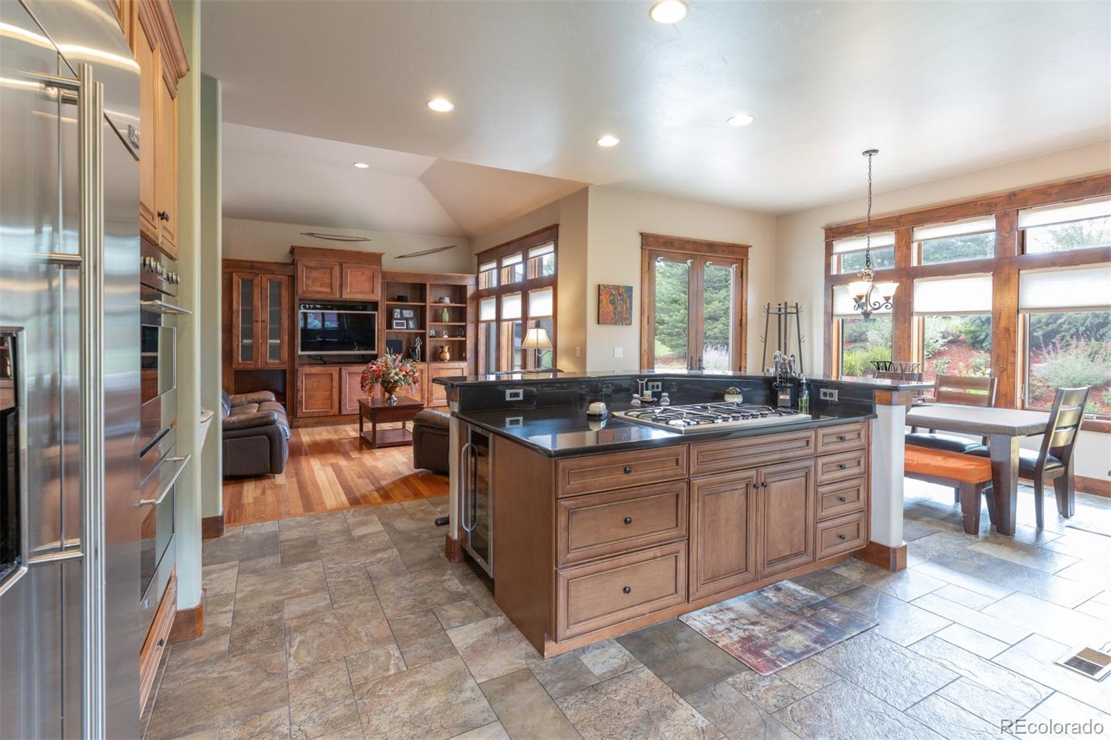 13680 Wide Acres Road Golden, CO 80401 - Photo 17 of 26 a large kitchen with kitchen island granite countertop a large counter top and stainless steel appliances