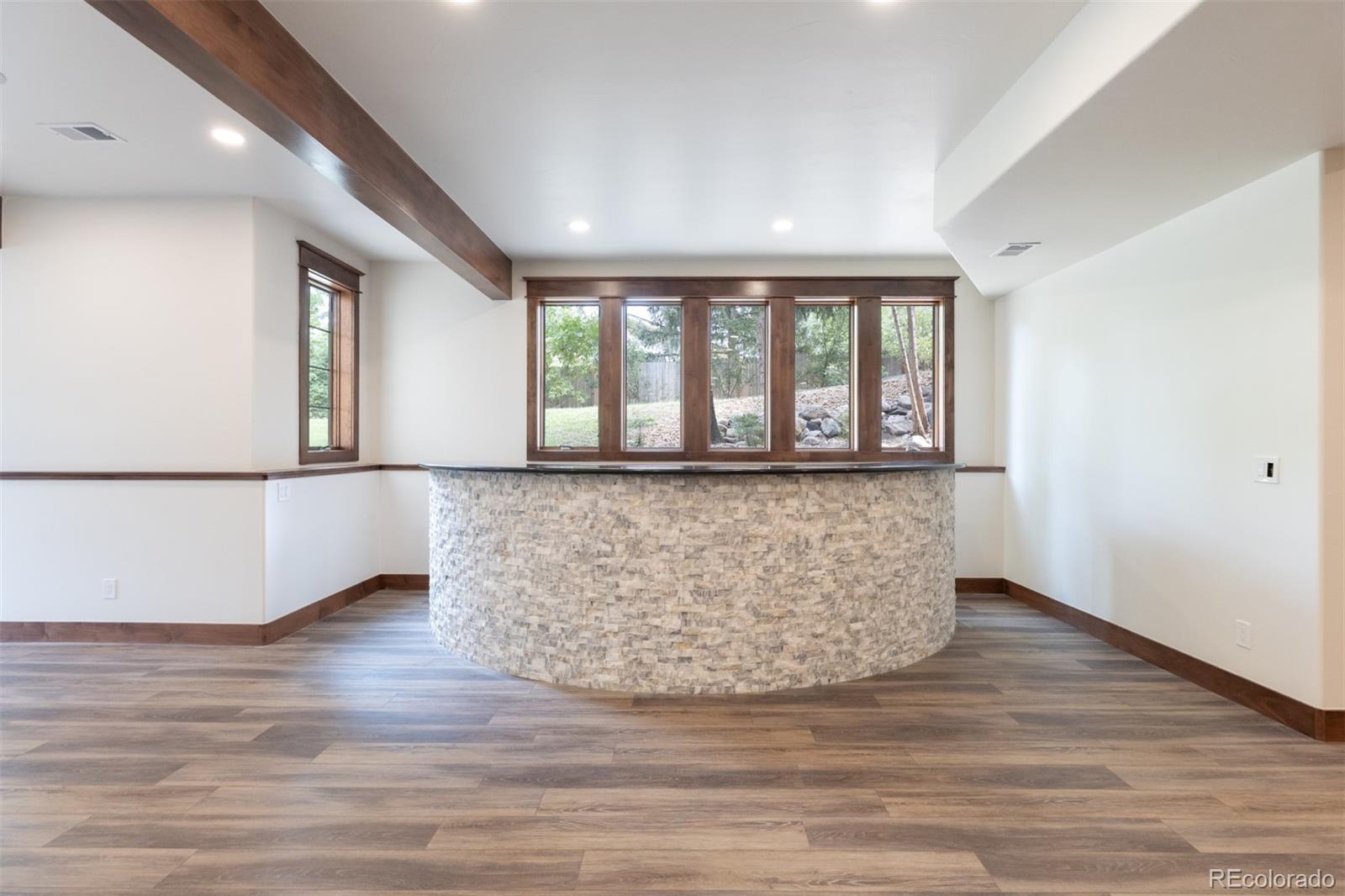13680 Wide Acres Road Golden, CO 80401 - Photo 18 of 26 a view of empty room with wooden floor and fan