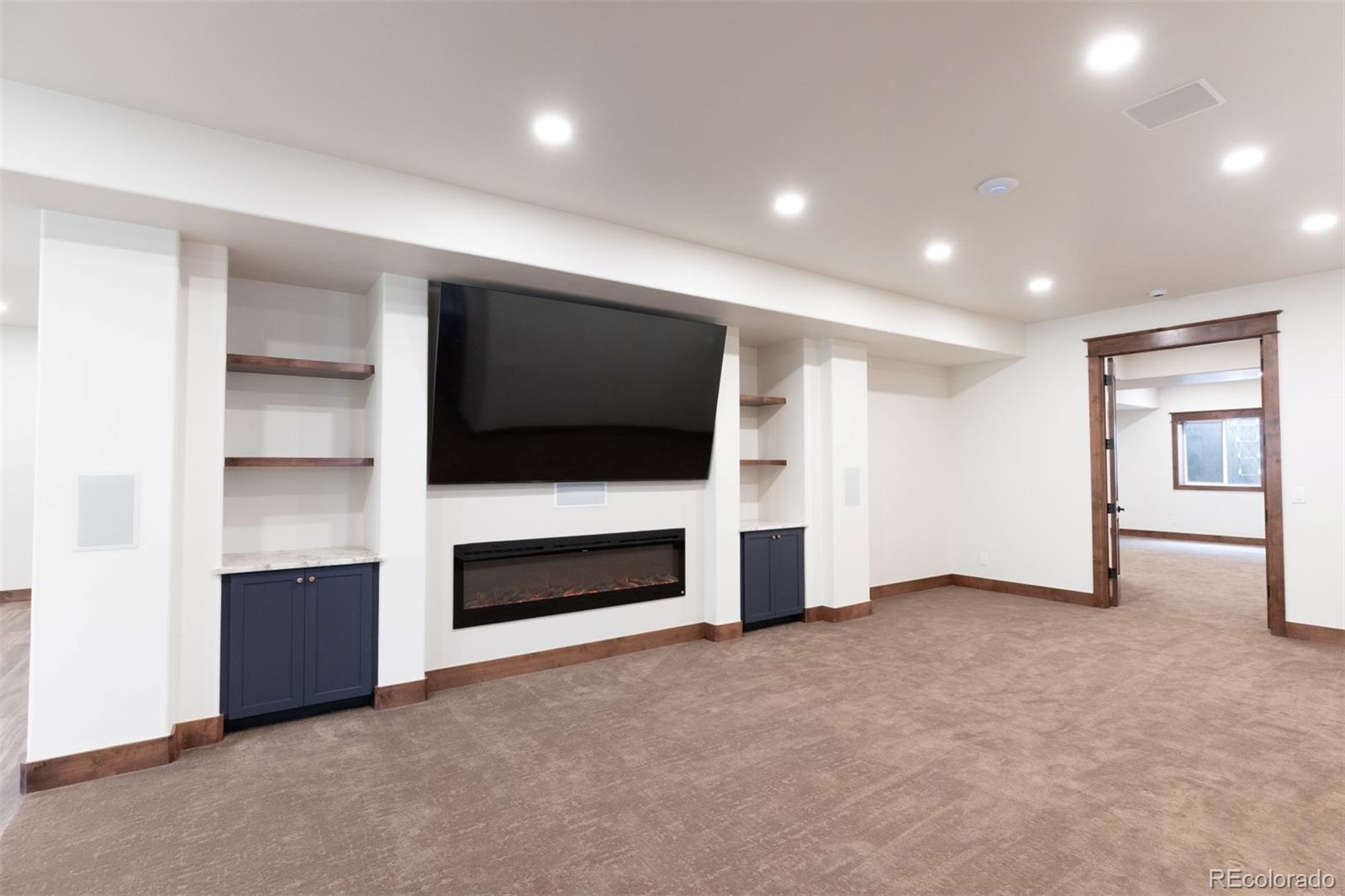 13680 Wide Acres Road Golden, CO 80401 - Photo 20 of 26 a view of empty room with a flat screen tv and fireplace