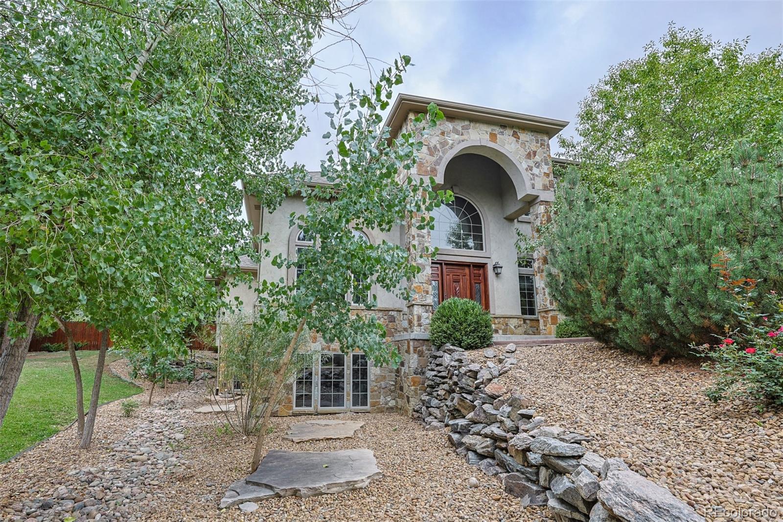 13680 Wide Acres Road Golden, CO 80401 - Photo 2 of 26 a front view of a house with garden