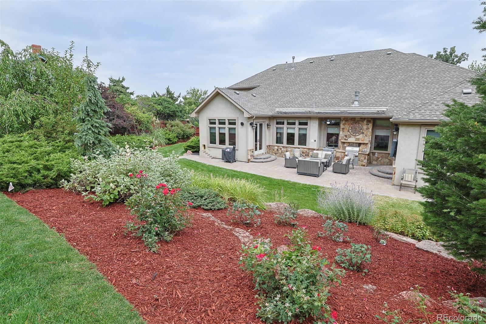 13680 Wide Acres Road Golden, CO 80401 - Photo 25 of 26 a view of a house with garden and sitting area