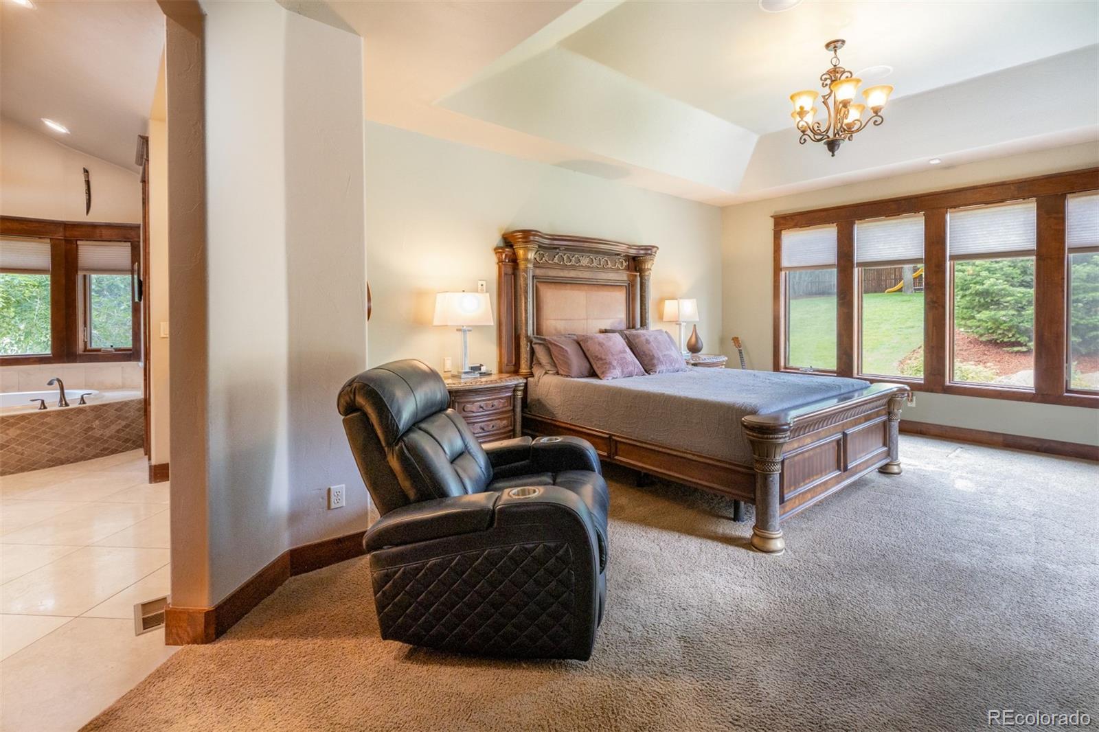 13680 Wide Acres Road Golden, CO 80401 - Photo 5 of 26 a bedroom with a bed couch and a window