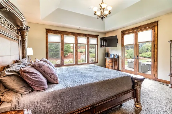 a bed sitting in a bedroom next to a large window