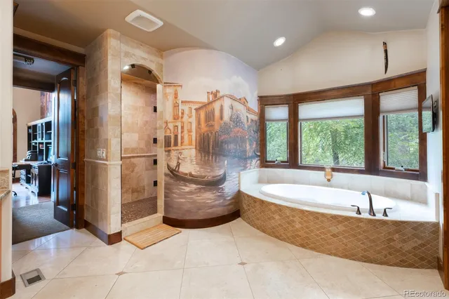 a spacious bathroom with a tub and shower