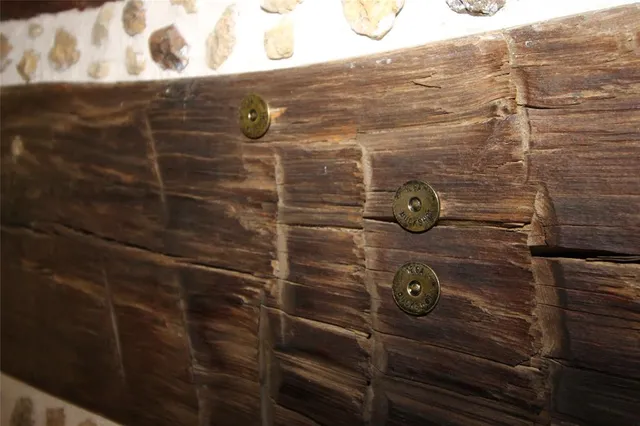 a view of a room that has a bed and a table in it