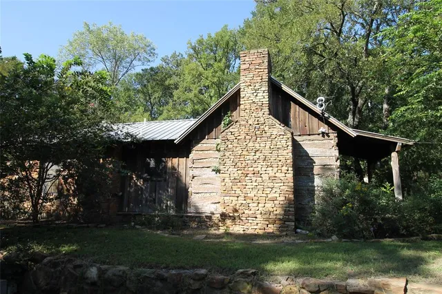 a view of outdoor space with green field and trees all around