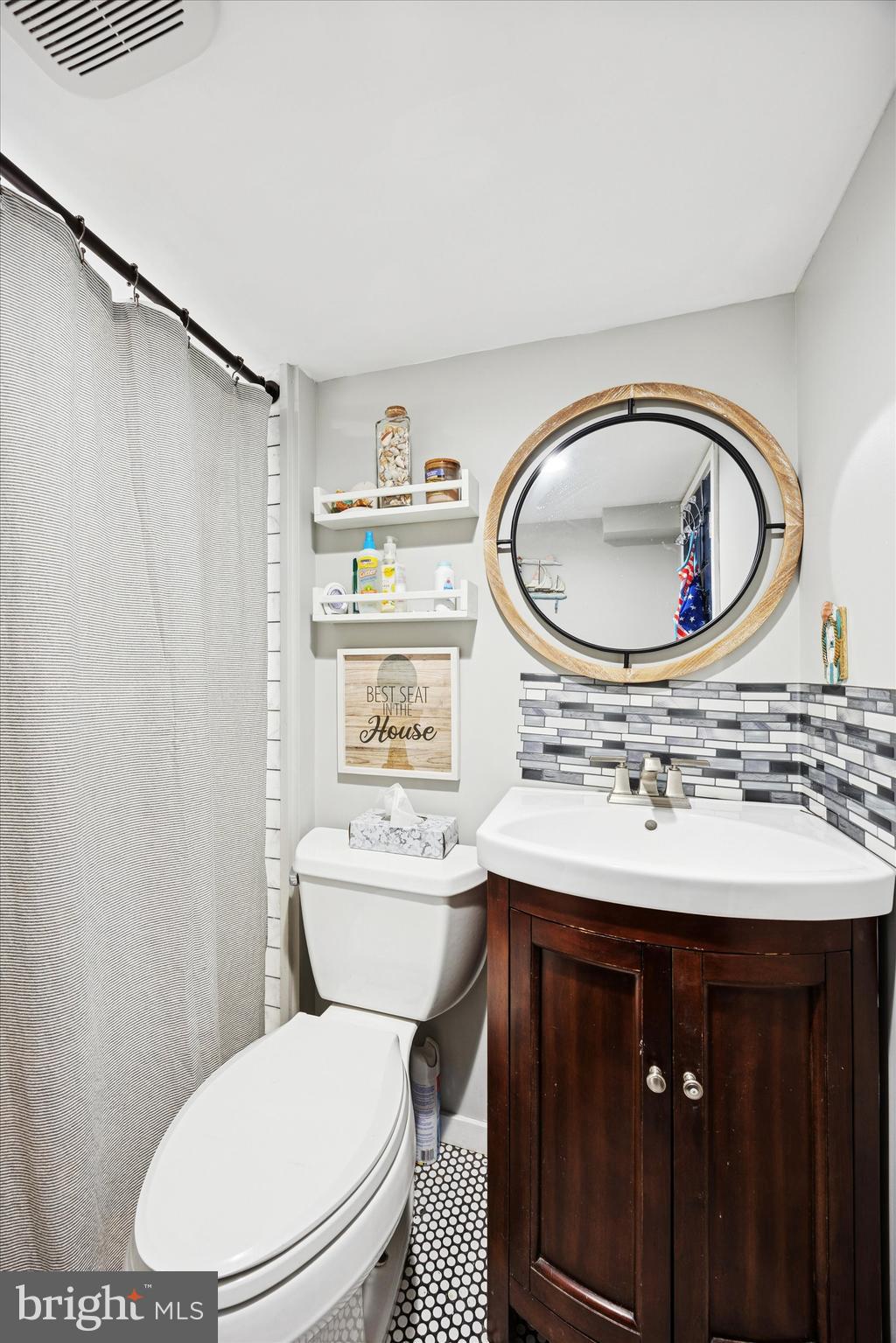 515 Corsons Tavern Road, Unit E 42 Ocean View, NJ 08230 - Photo 11 of 25 a bathroom with a sink a toilet and a mirror