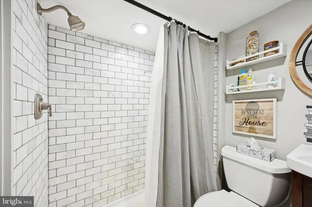 a bathroom with a shower toilet and sink