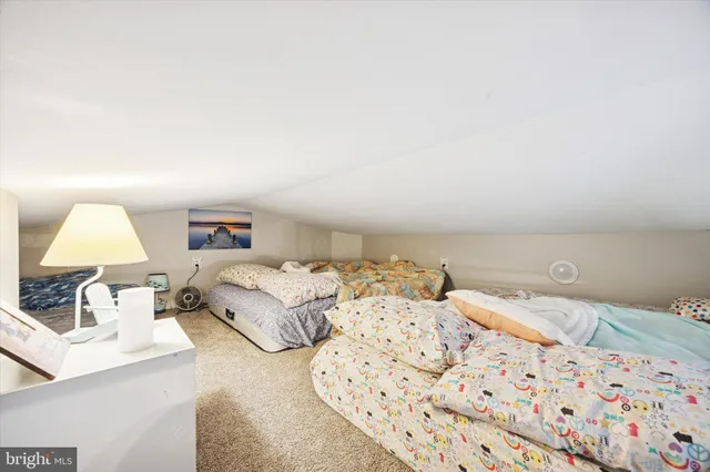 a bedroom with a bed and a lamp