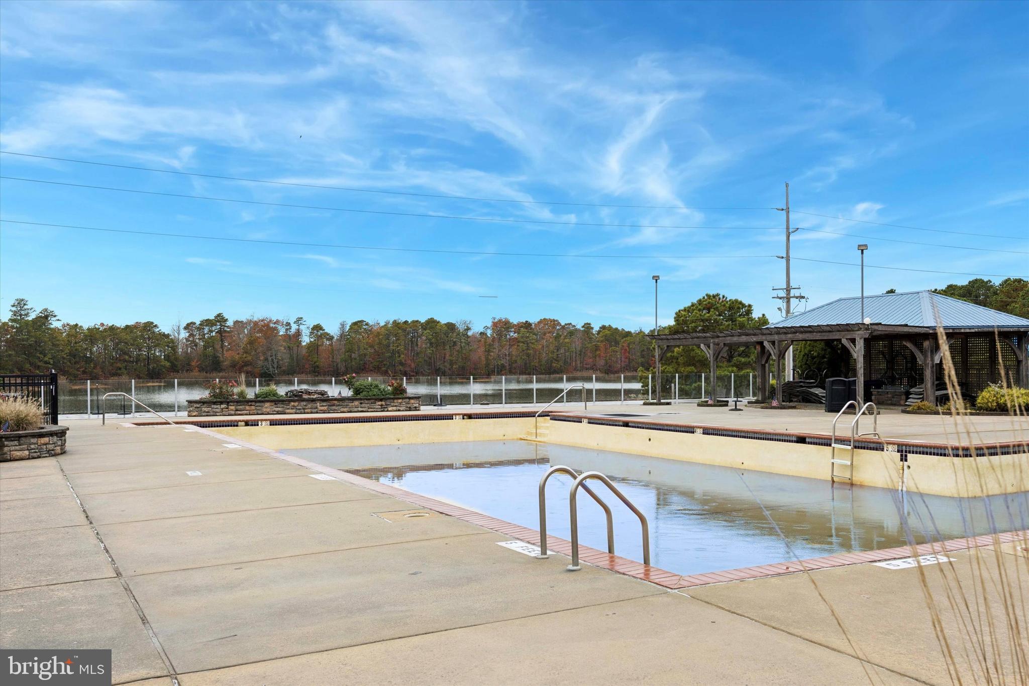 515 Corsons Tavern Road, Unit E 42 Ocean View, NJ 08230 - Photo 24 of 25 a view of a swimming pool with a lounge chair