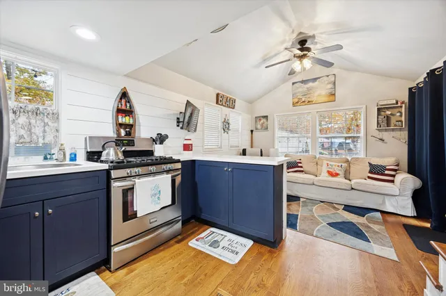 a kitchen with a sink appliances and cabinets