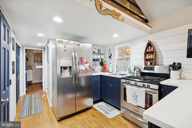 a kitchen with stainless steel appliances granite countertop a refrigerator and a stove