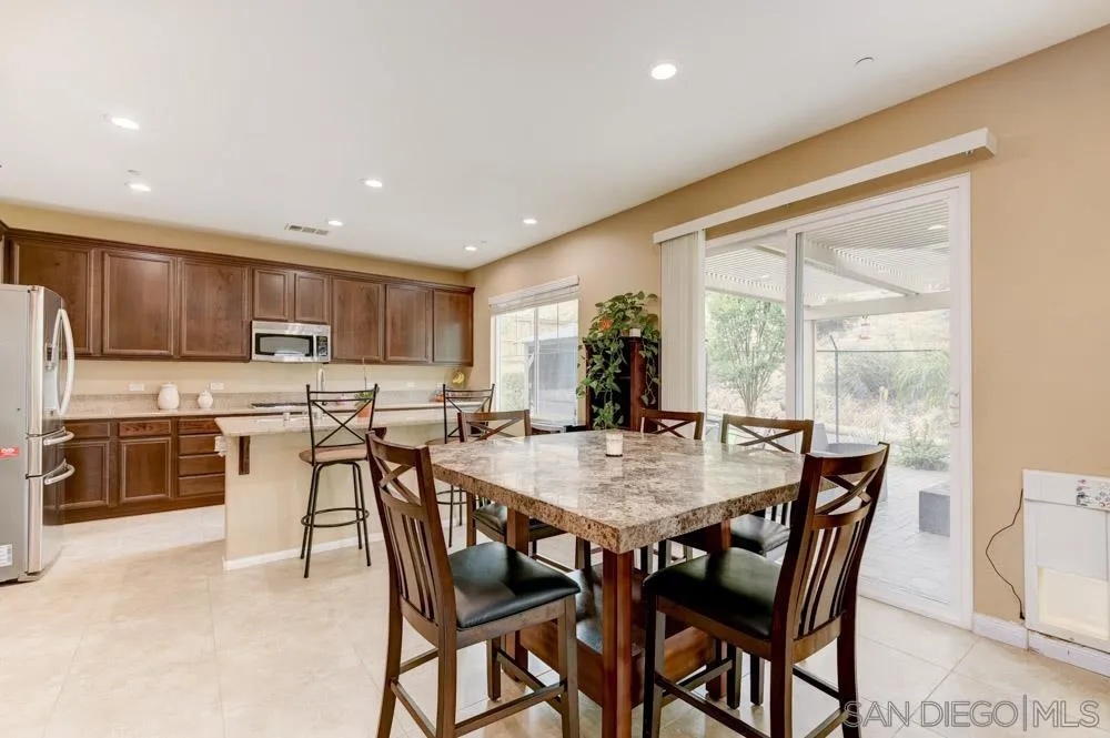 a view of a dining room and kitchen with a table chairs a workspace