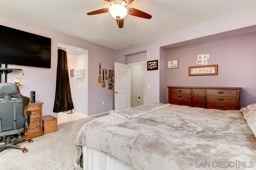 1145 Los Senderos Drive Santee, CA 92071 - Photo 17 of 30 a bedroom with a bed and a flat screen tv