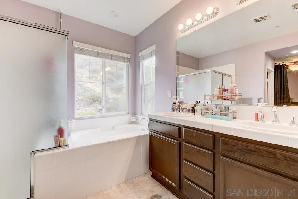 1145 Los Senderos Drive Santee, CA 92071 - Photo 18 of 30 a bathroom with a tub sink and mirror