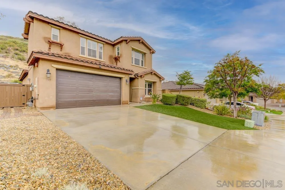 1145 Los Senderos Drive Santee, CA 92071 - Photo 2 of 30 a front view of a house with a yard and garage