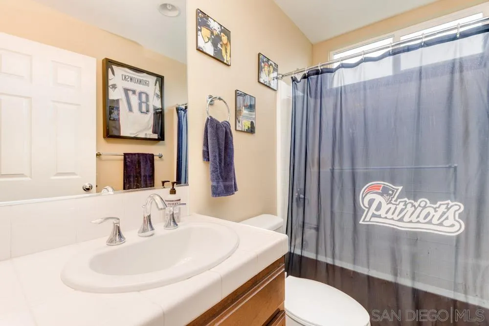 1145 Los Senderos Drive Santee, CA 92071 - Photo 24 of 30 a bathroom with a sink toilet and shower