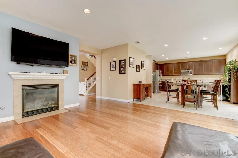 1145 Los Senderos Drive Santee, CA 92071 - Photo 6 of 30 a living room with furniture a flat screen tv and a fireplace