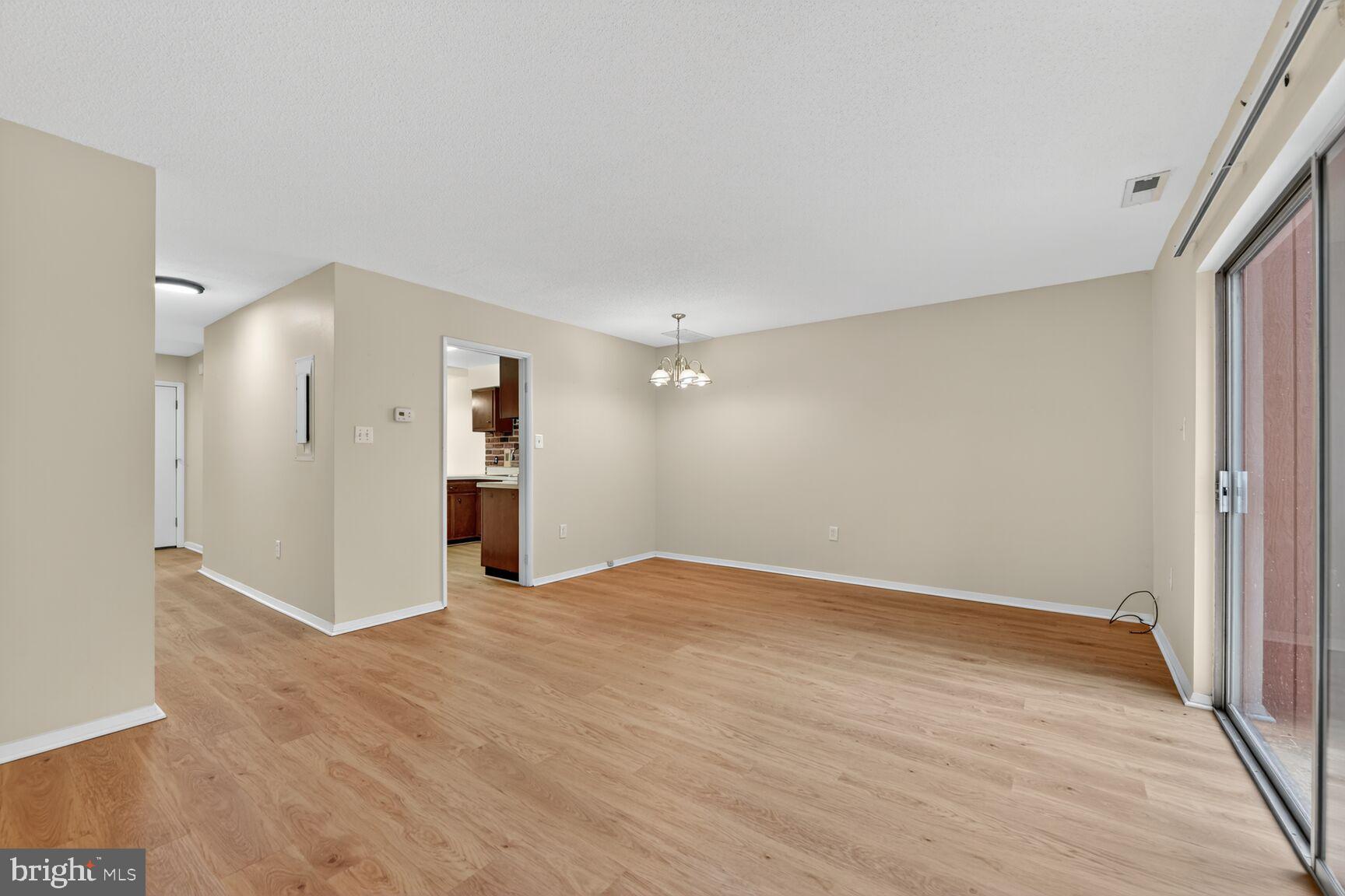 1384 Northgate Square Reston, VA 20190 - Photo 11 of 19 a view of empty room with wooden floor and entryway