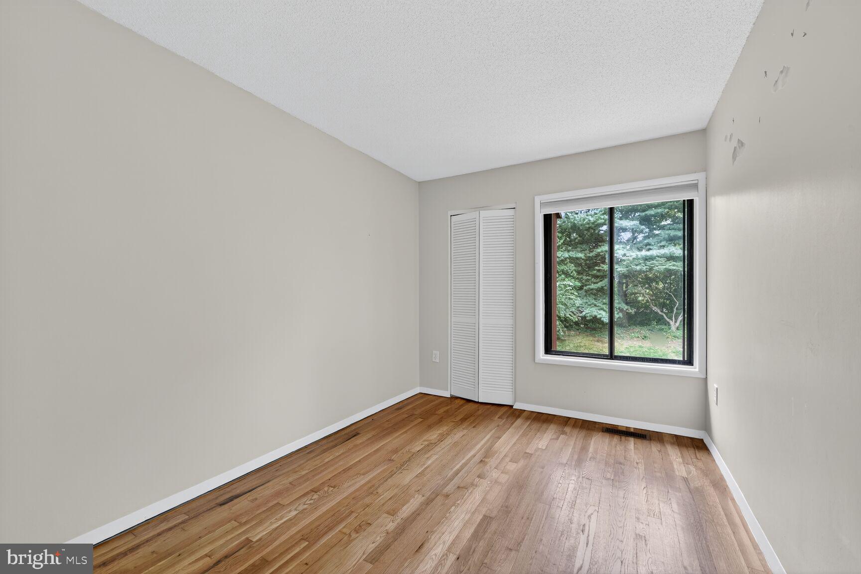 1384 Northgate Square Reston, VA 20190 - Photo 14 of 19 an empty room with wooden floor and windows