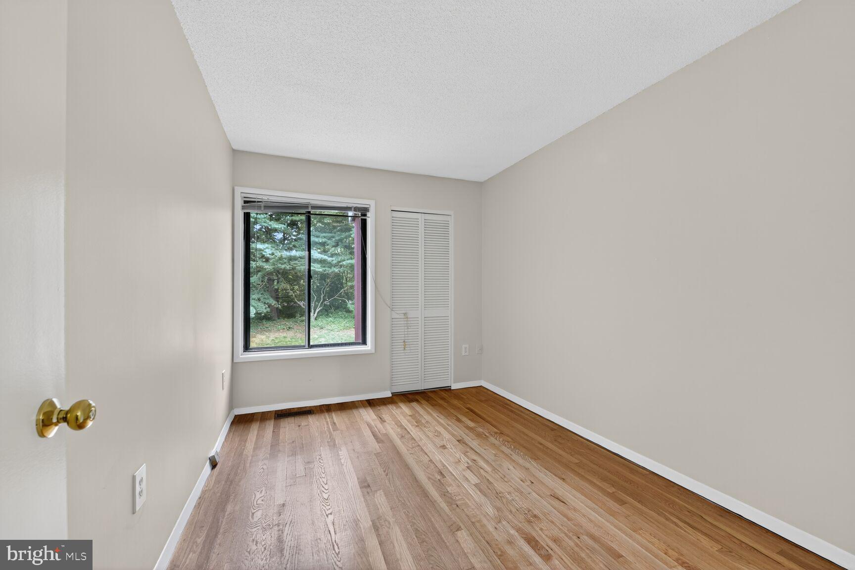 1384 Northgate Square Reston, VA 20190 - Photo 15 of 19 a view of an empty room with wooden floor and a window