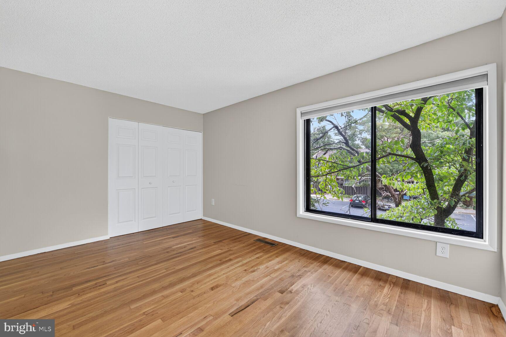 1384 Northgate Square Reston, VA 20190 - Photo 18 of 19 a view of an empty room with wooden floor and a window